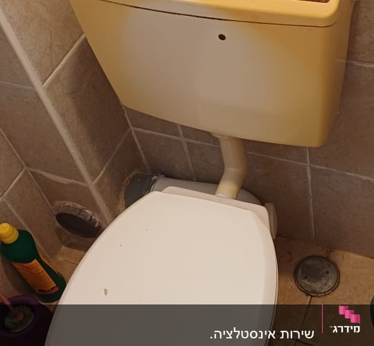 אסלה ומיכל הדחה בחדר אמבטיה